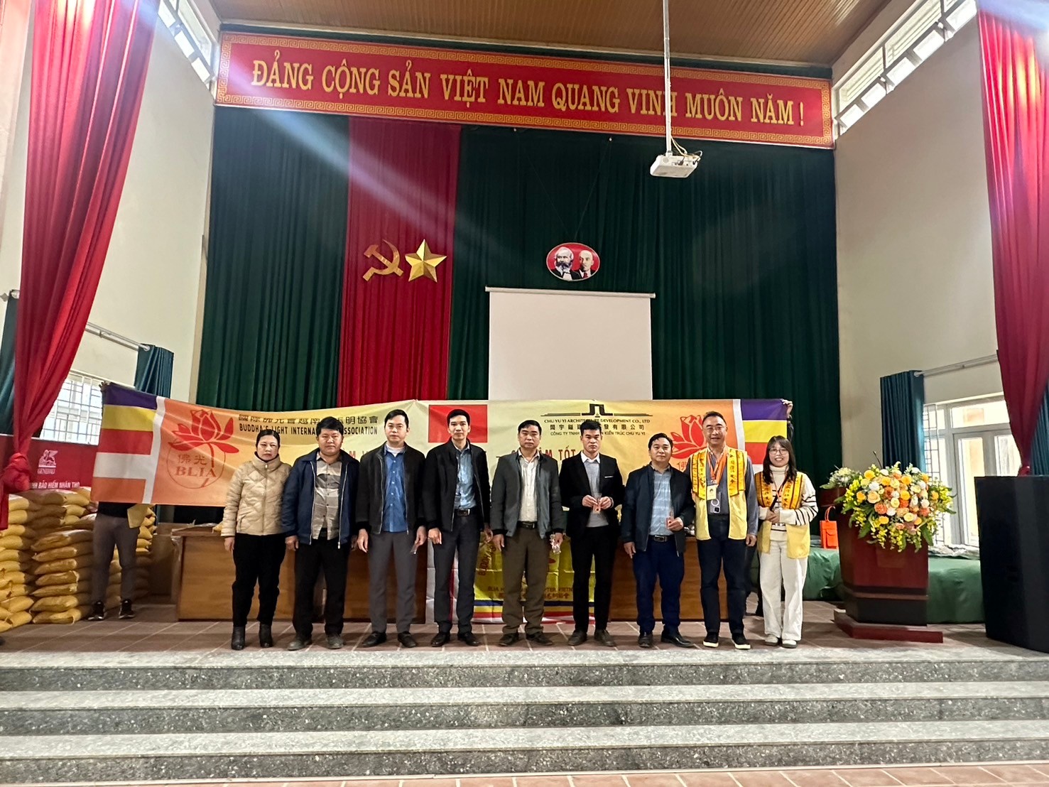 A group of people standing on a stage

Description automatically generated