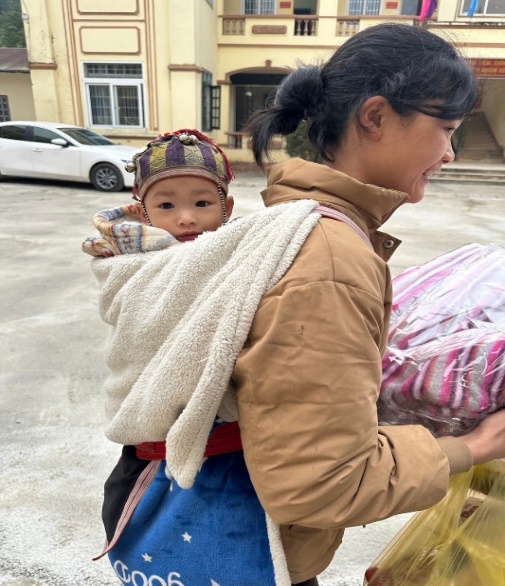 A person carrying a baby

Description automatically generated