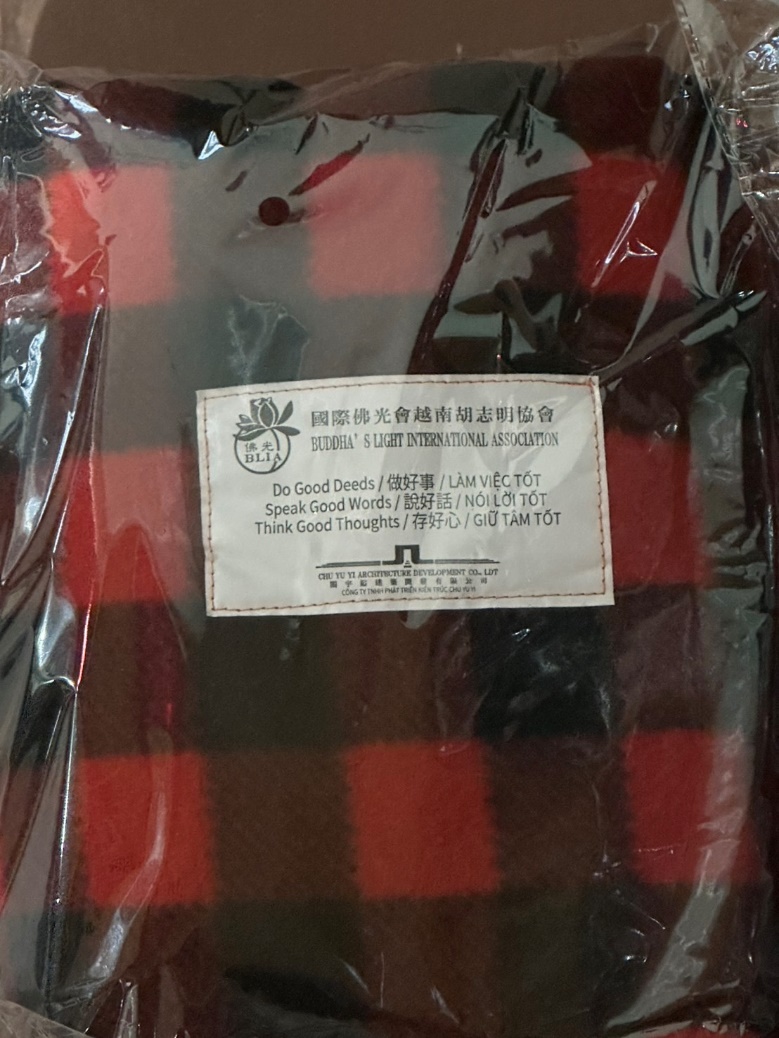A red and black plaid flannel in a plastic bag

Description automatically generated