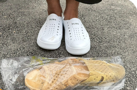 A person's feet in white shoes

AI-generated content may be incorrect.